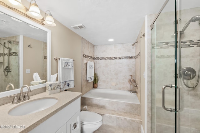 full bathroom featuring independent shower and bath, vanity, and toilet