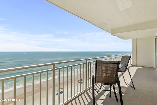 balcony with a view of the beach and a water view