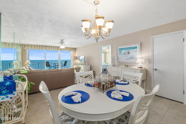 dining room with ceiling fan with notable chandelier and light tile patterned floors