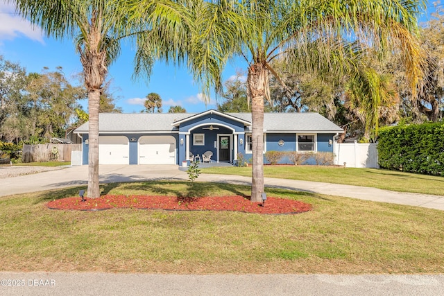 ranch-style house with driveway, a garage, fence, and a front yard