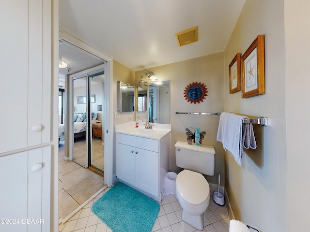 bathroom featuring vanity, tile patterned floors, toilet, and ceiling fan