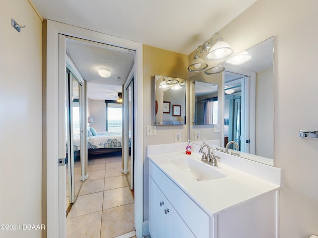 bathroom featuring vanity, a textured ceiling, and tile patterned floors