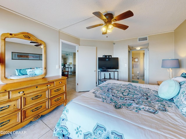 bedroom with light tile patterned flooring, ceiling fan, and a textured ceiling