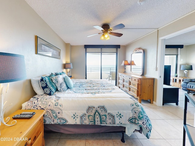 tiled bedroom with a textured ceiling and ceiling fan