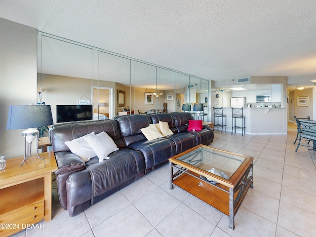 tiled living room featuring a textured ceiling