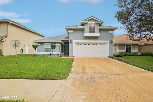 view of front of home featuring a front yard and a garage