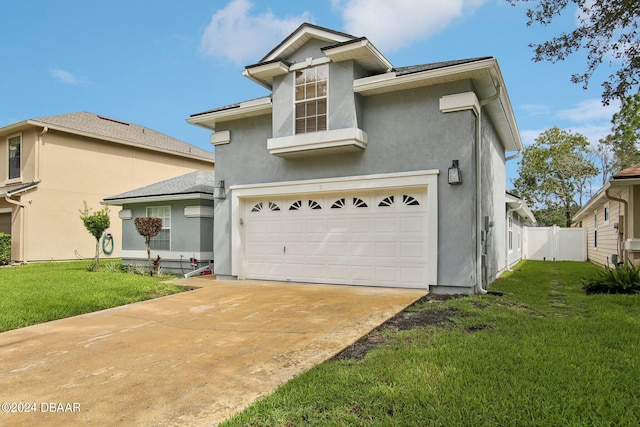 view of front of house featuring a garage and a front lawn