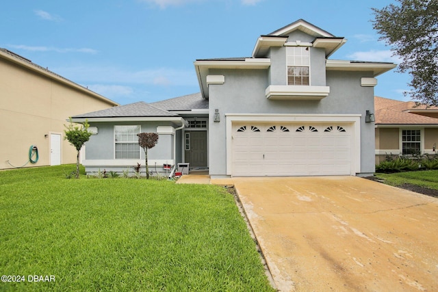 view of front of property with a front yard and a garage