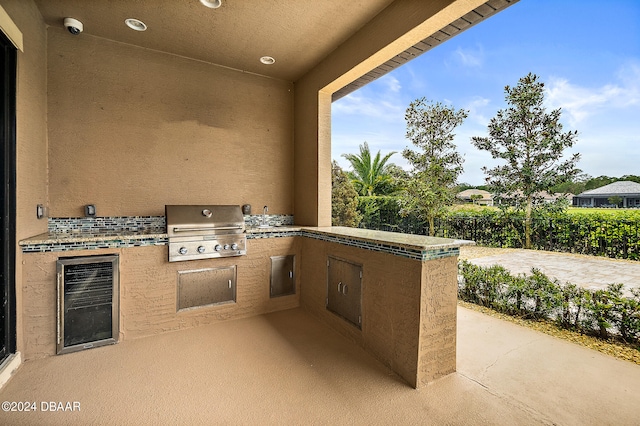 view of patio featuring grilling area, area for grilling, and wine cooler