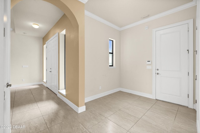 foyer featuring ornamental molding and light tile patterned floors