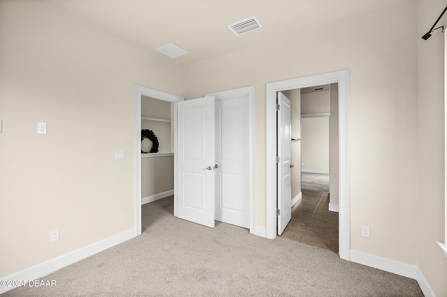 unfurnished bedroom featuring light colored carpet