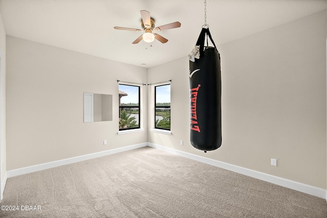 spare room featuring carpet floors and ceiling fan