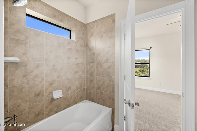 bathroom featuring tiled shower / bath