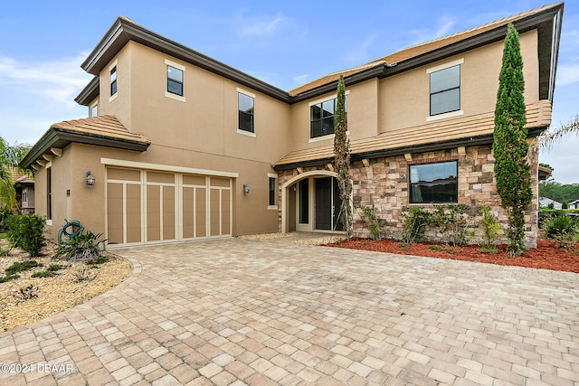 back of property featuring a garage