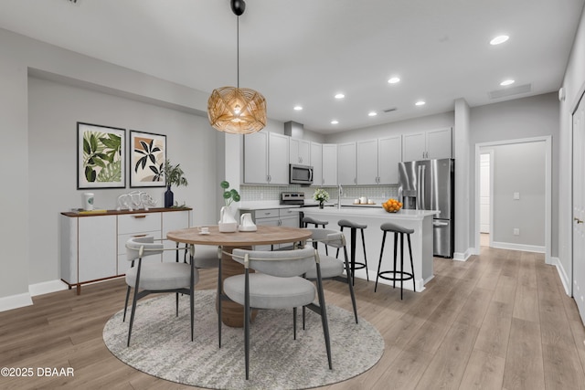 dining space with light hardwood / wood-style floors