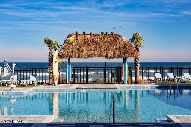 view of swimming pool featuring a gazebo and a water view