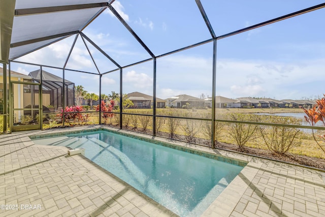 view of pool featuring glass enclosure and a patio area