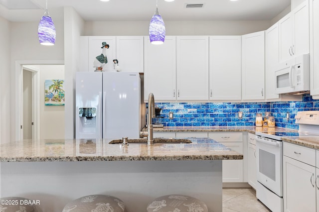 kitchen featuring visible vents, backsplash, white cabinetry, a sink, and white appliances