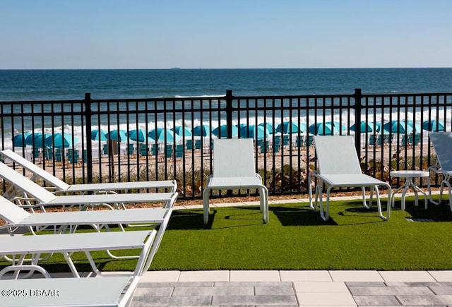 exterior space featuring a water view and a beach view