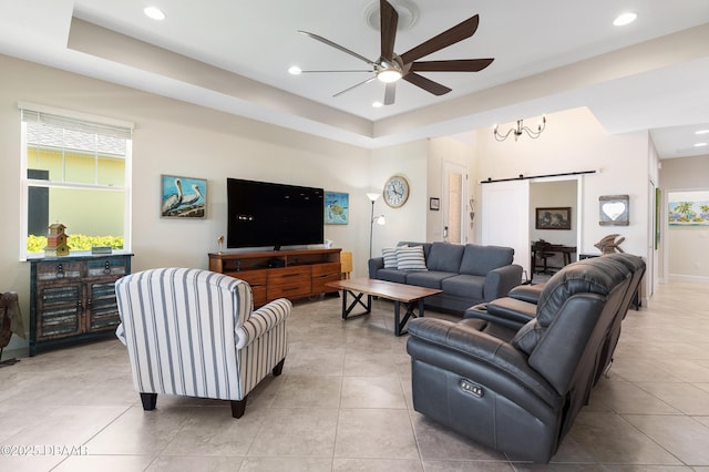 living room featuring light tile patterned floors, a barn door, a ceiling fan, and recessed lighting