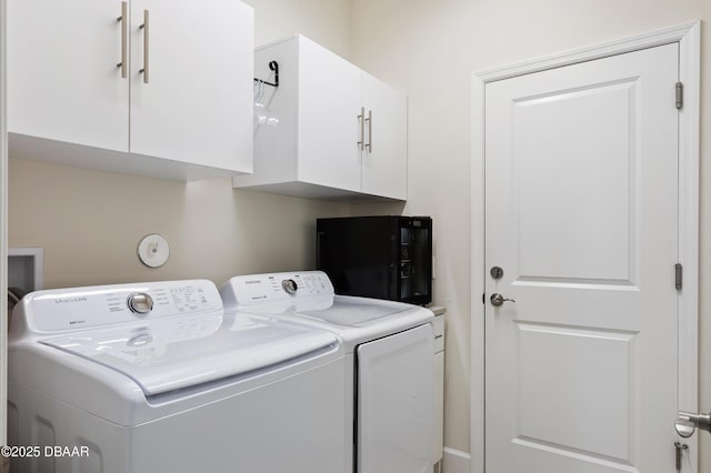 laundry room featuring cabinet space and washer and clothes dryer