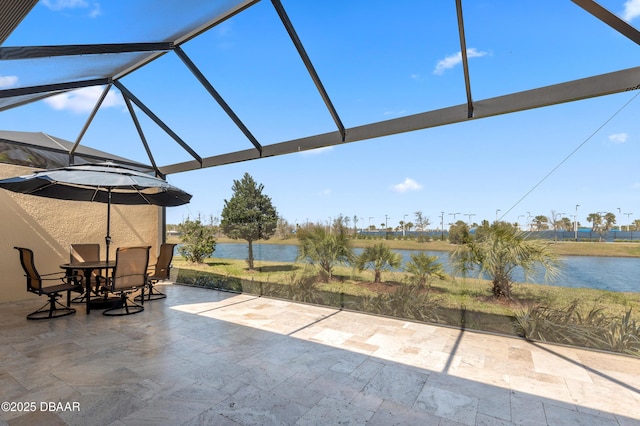 view of patio featuring a water view, a lanai, and outdoor dining area