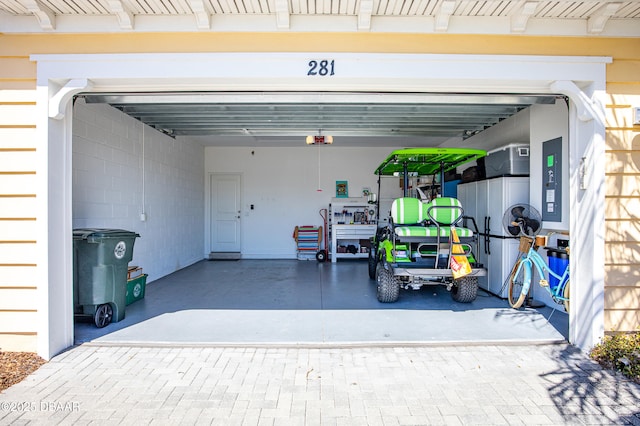 garage with decorative driveway and a garage door opener