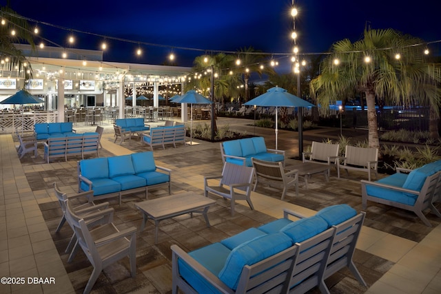 patio at night featuring an outdoor hangout area