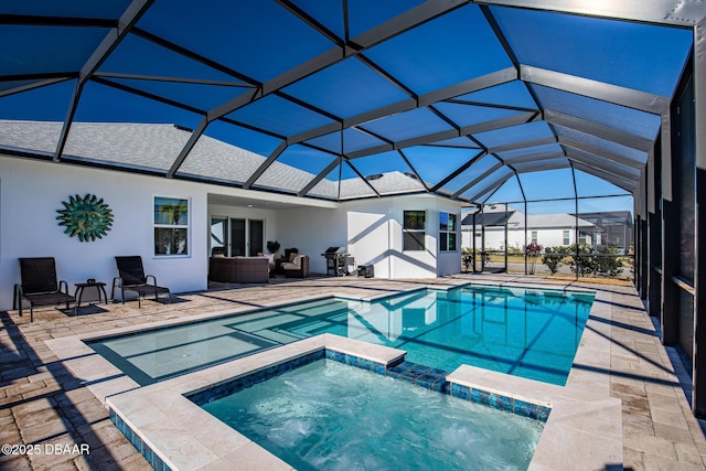 view of swimming pool featuring an outdoor hangout area, glass enclosure, a patio area, and a pool with connected hot tub