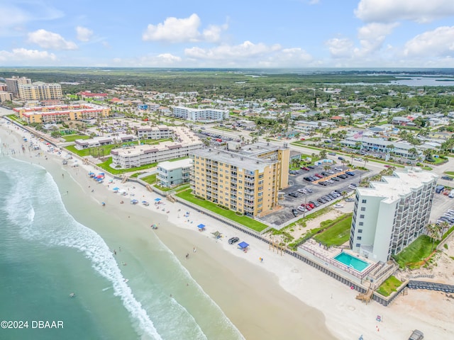 drone / aerial view with a beach view and a water view