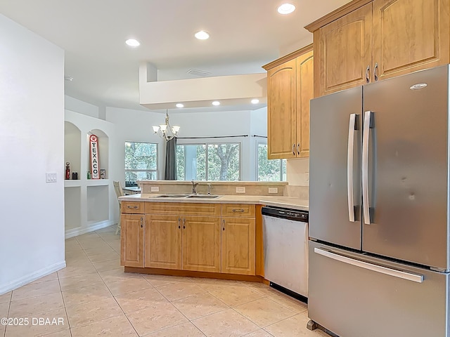 12 Kathleen Trl, Palm Coast, FL 32164 - kitchen featuring appliances with stainless steel finishes, a sink, light tile patterned floors, light countertops, and recessed lighting