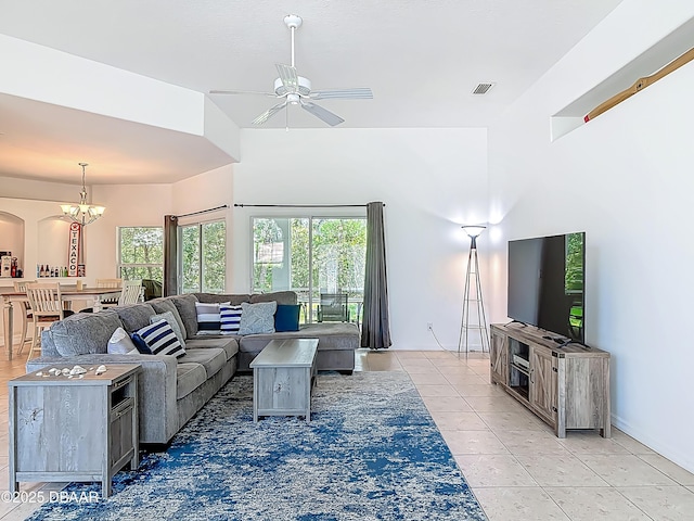 12 Kathleen Trl, Palm Coast, FL 32164 - living room with a chandelier, a ceiling fan, light tile patterned floors, healthy amount of natural light, and a high ceiling