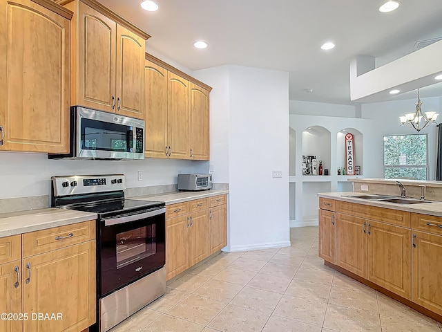 12 Kathleen Trl, Palm Coast, FL 32164 - kitchen with appliances with stainless steel finishes, a sink, light countertops, recessed lighting, and light tile patterned floors