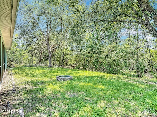 12 Kathleen Trl, Palm Coast, FL 32164 - view of green lawn featuring a fire pit
