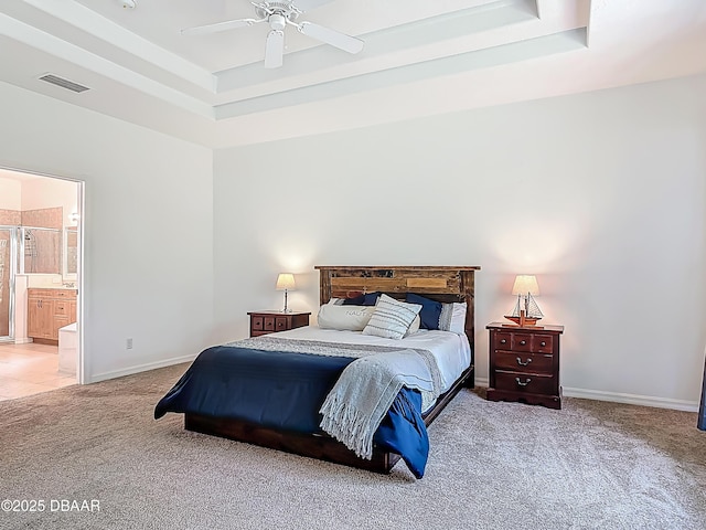 12 Kathleen Trl, Palm Coast, FL 32164 - bedroom with carpet, a tray ceiling, baseboards, ensuite bath, and ceiling fan