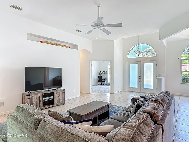 12 Kathleen Trl, Palm Coast, FL 32164 - living area with ceiling fan, french doors, light tile patterned floors, baseboards, and arched walkways