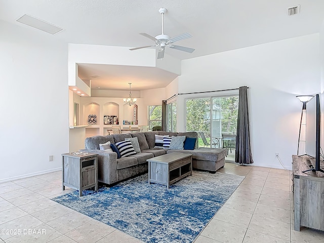 12 Kathleen Trl, Palm Coast, FL 32164 - living room featuring light tile patterned flooring, a ceiling fan, a chandelier, a high ceiling, and baseboards