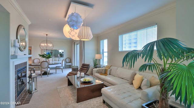 carpeted living room with a fireplace, a notable chandelier, and ornamental molding