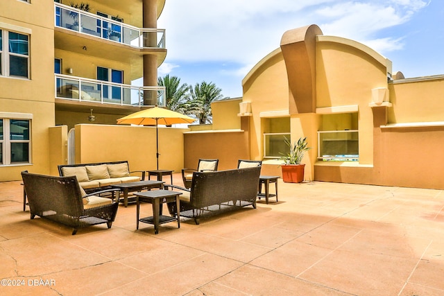 view of patio with a balcony and an outdoor hangout area