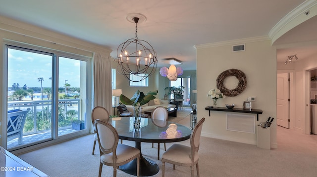 dining room featuring a wealth of natural light, light colored carpet, an inviting chandelier, and ornamental molding