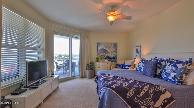 bedroom featuring light colored carpet, ceiling fan, and access to outside