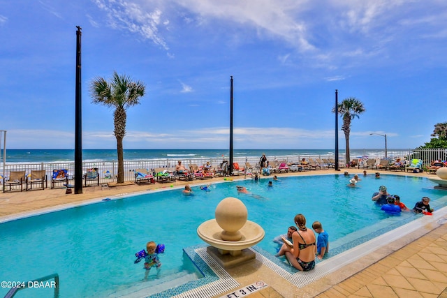 view of pool with a water view