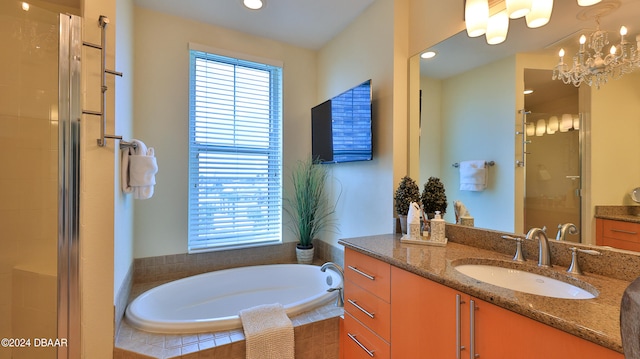 bathroom with vanity, plus walk in shower, and an inviting chandelier