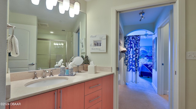 bathroom with walk in shower and vanity