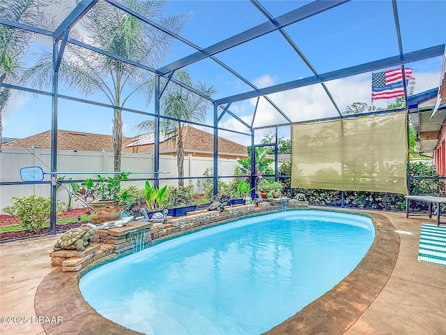 view of swimming pool featuring glass enclosure, a patio area, fence, and a fenced in pool