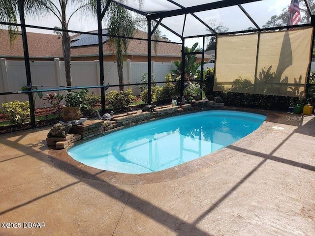 view of swimming pool featuring a fenced in pool, glass enclosure, fence, and a patio