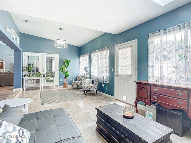 living area with french doors, visible vents, plenty of natural light, and baseboards