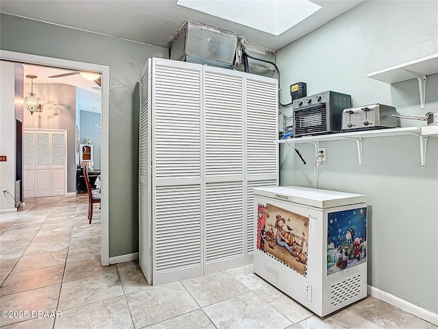 washroom with light tile patterned floors and baseboards