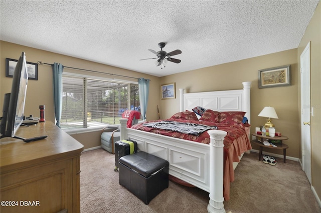 carpeted bedroom featuring a textured ceiling and ceiling fan