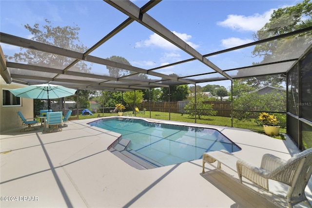 view of pool with a lawn, a lanai, and a patio